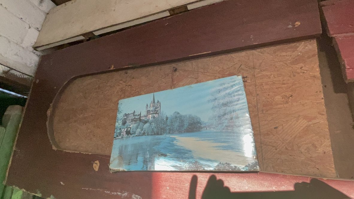 A faded picture of a snowy castle, pinned to a board
